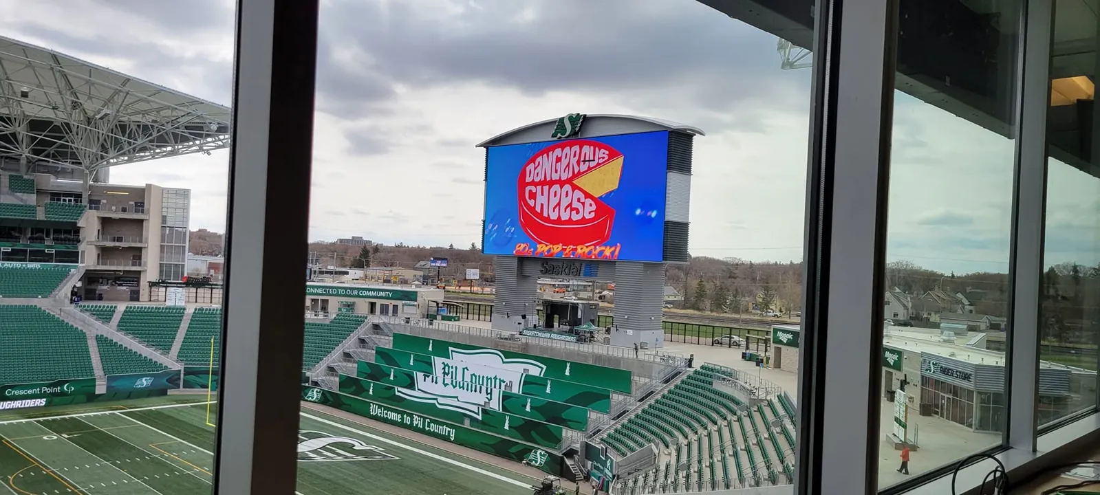 Mosaic Stadium scoreboard during Saskatchewan Roughriders Family Day with Dangerous Cheese performing